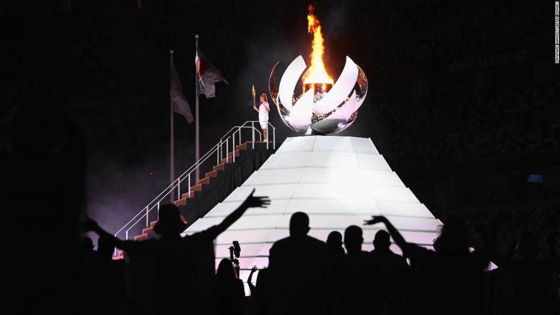 Japanese tennis star Naomi Osaka lights the Olympic cauldron at the end of the opening ceremony on Friday, July 23.