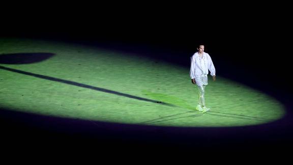 A lone performer is seen during the start of the opening ceremony.
