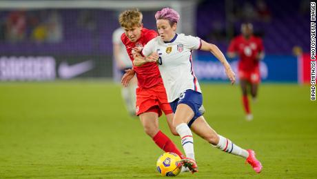 Megan Rapinoe (right) flies past Quinn of Canada during a game between Canada and the US Women&#39;s National Team in Florida. 