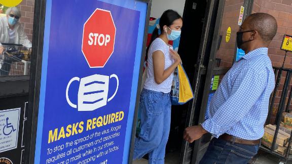 People shop at a grocery store enforcing the wearing of masks in Los Angeles on July 23, 2021.