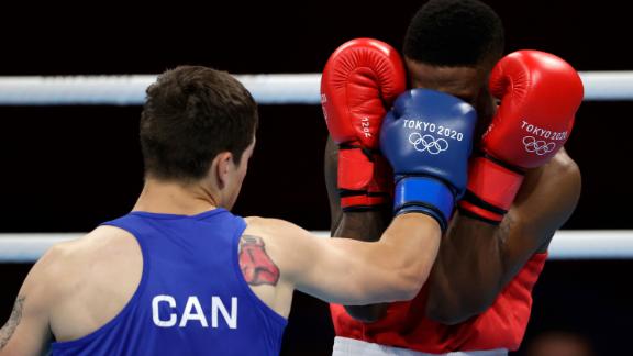 Canada's Wyatt Sanford hits Mauritius' Merven Clair during the men's welterweight event.