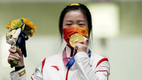 China's Yang Qian celebrates with her gold medal after winning the women's 10m air rifle on July 24. Qian was the first gold medal winner of the Olympic games. 