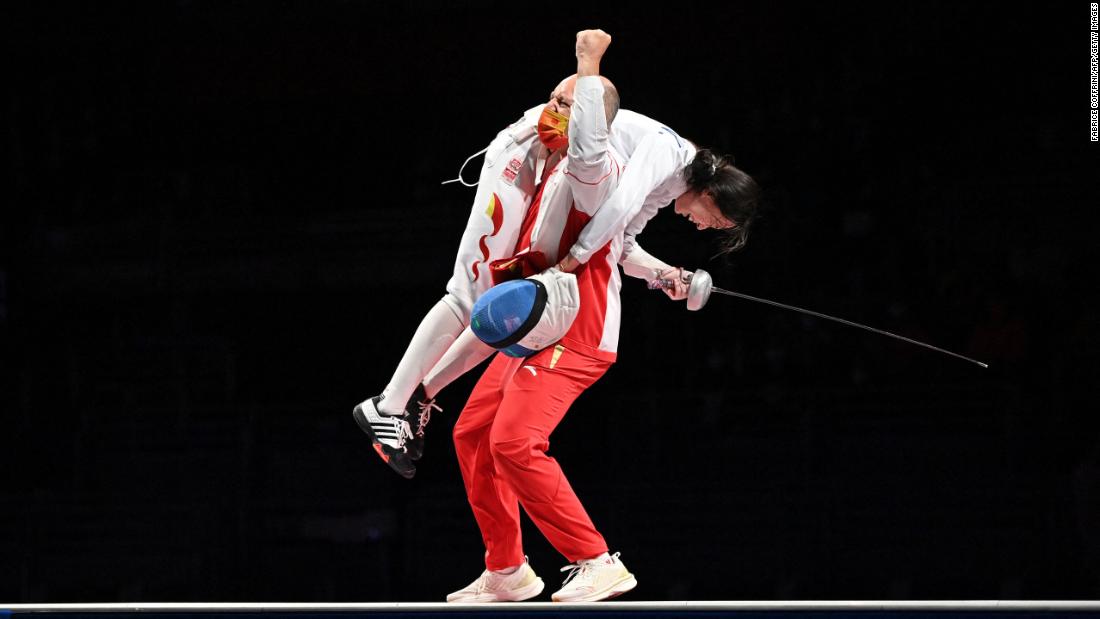 Chinese fencer Sun Yiwen celebrates with her coach Hugues Obry after winning gold in the épée on July 24.