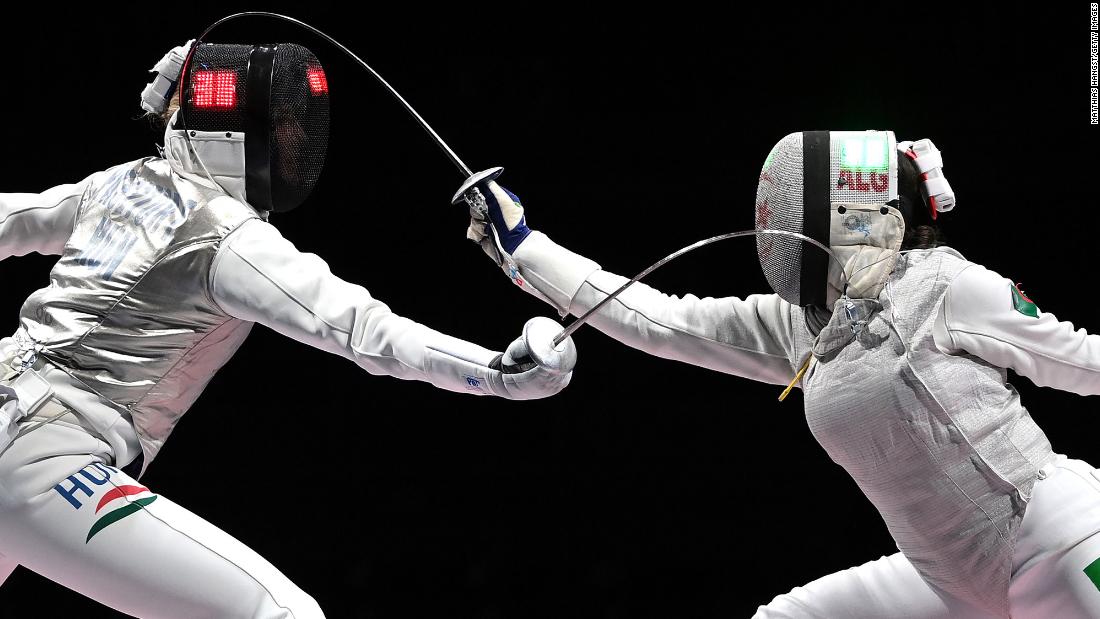 Hungarian fencer Flora Pasztor, left, competes against Algeria&#39;s Meriem Mebarki on July 25.