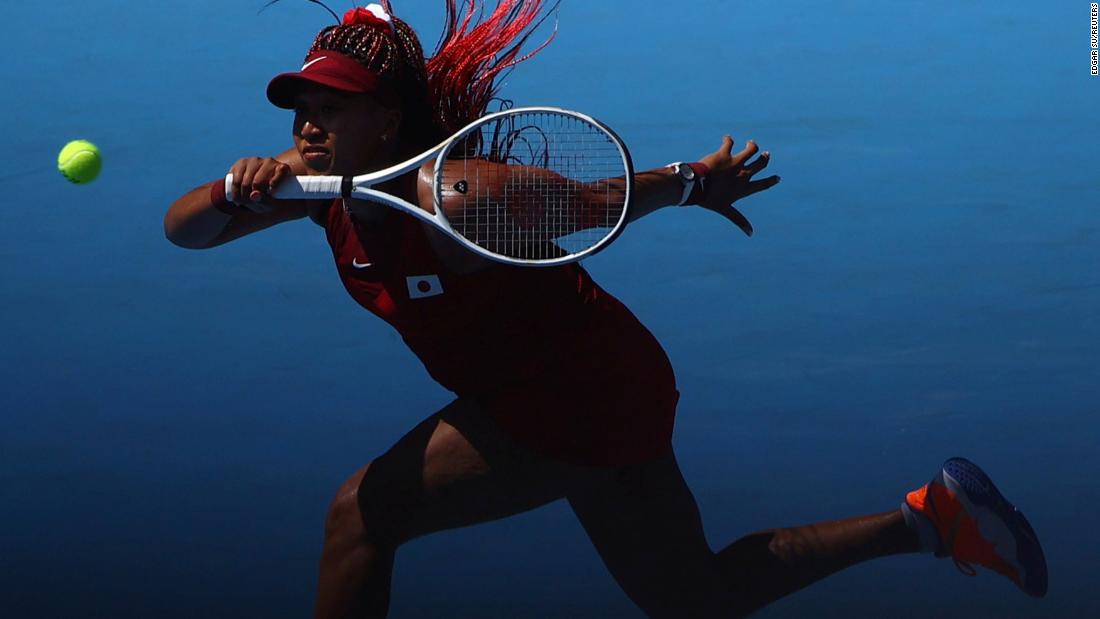 Japan&#39;s Naomi Osaka hits a forehand during her first-round match against China&#39;s Zheng Saisai on July 25. Osaka won 6-1, 6-4.