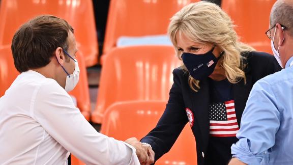 French President Emmanuel Macron and Biden shake hands ahead of the women's first round 3x3 basketball match between the US and France.