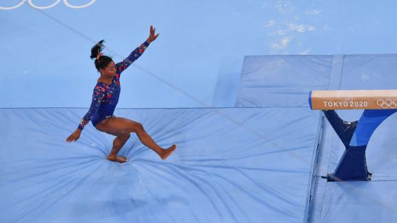 US gymnast Simone Biles stumbles on a balance beam dismount during the qualification event on July 25. She still qualified for the event finals, and the United States <a href=
