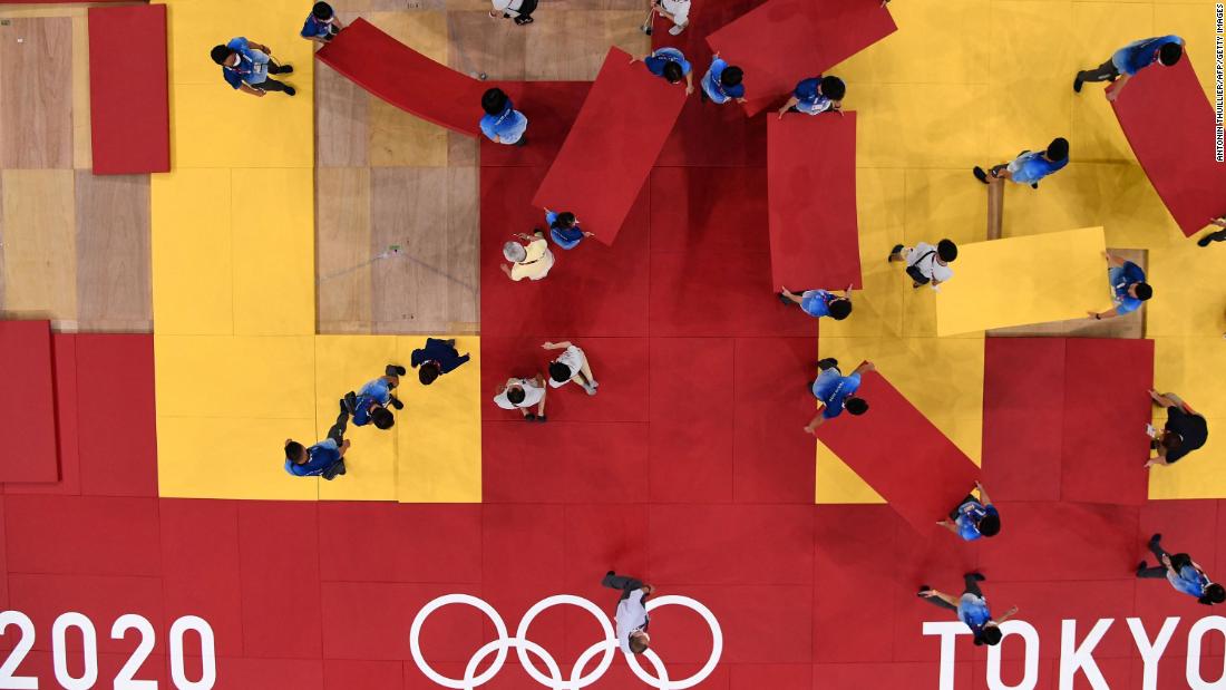 Staff members prepare for judo competition at the Budokan arena in Tokyo.