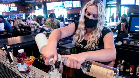 Bartender Olivia Imes prepares a drink for a customer at P.J. Whelihan's restaurant and pub in Spring Township, Pennsylvania, Friday evening June 25, 2021.