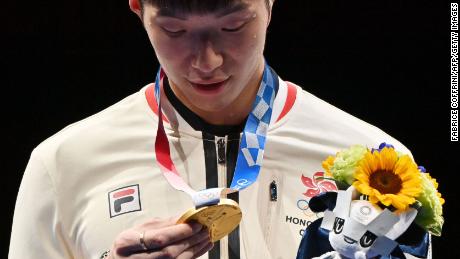 Fencing gold medallist Cheung Ka Long of Hong Kong looks at his medal while on the podium during the medal ceremony for the Men&#39;s Individual Foil during the Tokyo 2020 Olympic Games at the Makuhari Messe Hall in Chiba City, Chiba Prefecture, Japan, on July 26, 2021. 