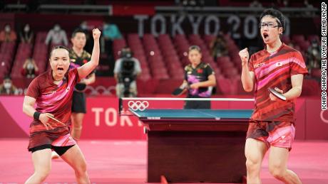 Mizutani Jun and Mima Ito of Japan cheer during the table tennis mixed doubles final against China on July 26.