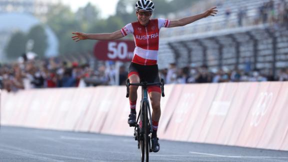 Anna Kiesenhofer crossed the finish line to win the women's cycling road race of the Tokyo Olympics on Sunday. 