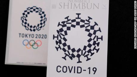 This photo illustration taken on May 21, 2020 in Tokyo shows the cover design of Number 1 Shimbun (R), the monthly magazine for members of the Foreign Correspondents Club of Japan, which was designed by Andrew Pothecary and the logo of Tokyo 2020 Olympic Games (L). - A satirical mock-up depicting the Tokyo Olympics logo as the new coronavirus has been pulled after Olympic organisers branded it &quot;insensitive&quot; and said it infringed copyright. (Photo by Kazuhiro NOGI / AFP) / RESTRICTED TO EDITORIAL USE - MANDATORY MENTION OF THE ARTIST UPON PUBLICATION - TO ILLUSTRATE THE EVENT AS SPECIFIED IN THE CAPTION (Photo by KAZUHIRO NOGI/AFP via Getty Images)