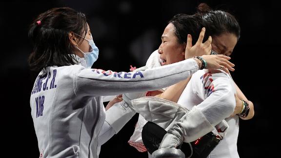 South Korean fencer Kang Young-mi, right, is congratulated by her teammates after they defeated the United States in the epée quarterfinals on July 27.