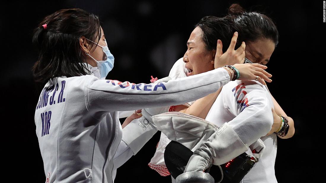 South Korean fencer Kang Young-mi, right, is congratulated by her teammates after they defeated the United States in the epée quarterfinals on July 27.