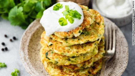 Zucchini fritters can be served with sour cream on top. 