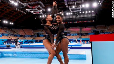 Simone Biles, of the United States, right, poses for pictures with teammate Jordan Chiles after an artistic gymnastics practice session at the 2020 Summer Olympics in Tokyo.