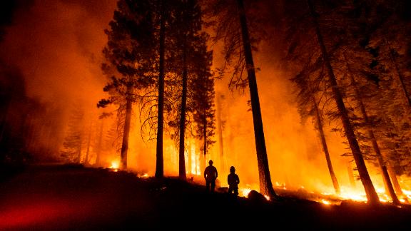 Cal Fire captains Derek Leong, right, and Tristan Gale watch as crews try to stop the Dixie Fire from spreading. (AP Photo/Noah Berger)