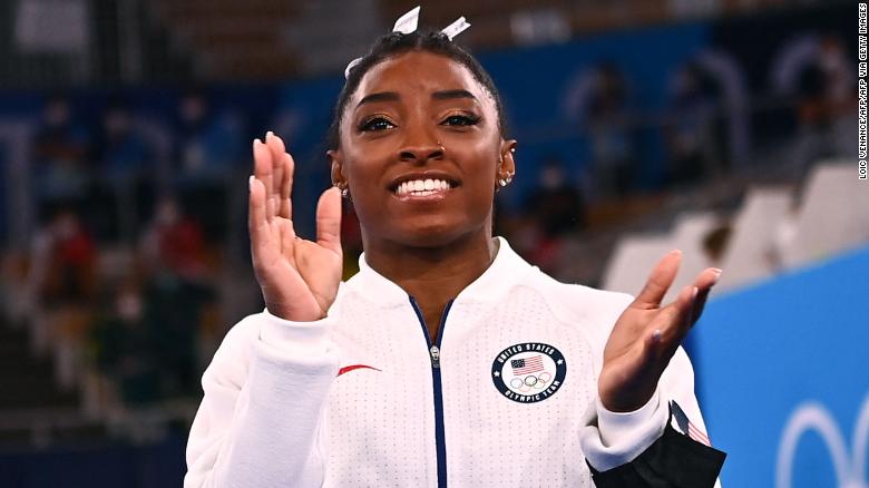 Simone Biles applauds during the artistic gymnastics women's team final during the 2020 Olympic Games.