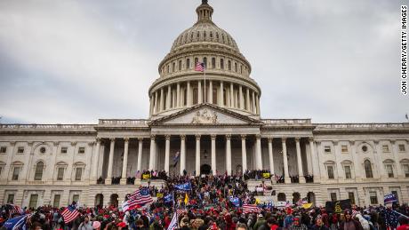 A large group of rioters stand on the East steps of the Capitol Building after storming its grounds on January 6, 2021 in Washington, DC. 