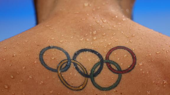 A tattoo of the Olympic rings is seen on the back of South African swimmer Brad Tandy on July 27. Many of this year's athletes <a href=