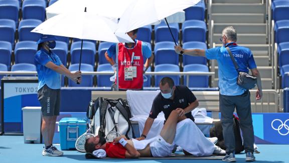 Russian tennis player Daniil Medvedev receives medical treatment during his third-round singles match on July 28. Midway through the match, the Russian — known for his dry humor and sarcasm — approached the chair umpire <a href=