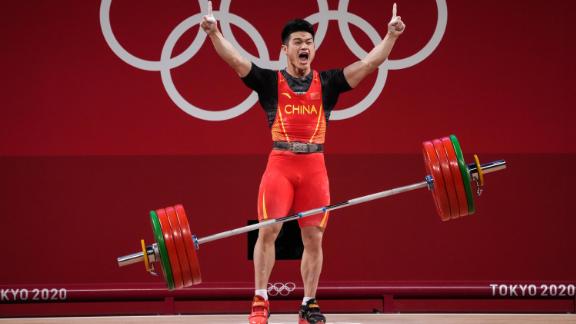 Chinese weightlifter Shi Zhiyong celebrates July 28 after winning gold in the 73-kilogram weight class. He lifted 166 kilograms in the snatch and 198 kilograms in the clean-and-jerk, setting <a href=