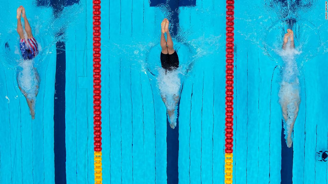 From left, the United States&#39; Bobby Finke, Ukraine&#39;s Mykhailo Romanchuk and Germany&#39;s Florian Wellbrock dive in the water at the start of the 800-meter freestyle final on July 29. Finke won gold after a late rally.