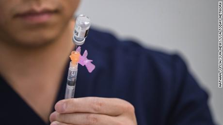 Kaleb Zhang fills syringes with the COVID-19 vaccine at a vaccination clinic at the Hatch Community Center in Hatch, New Mexico on Saturday, July 24, 2021.