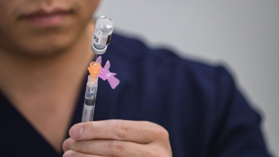 Kaleb Zhang fills syringes with the vaccine for COVID-19 at a vaccination clinic at the Hatch Community Center in Hatch, New Mexico, Saturday, July 24, 2021.