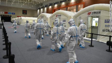 Workers prepare a pop-up Covid-19 testing lab at an expo center in Nanjing, China, on July 28.