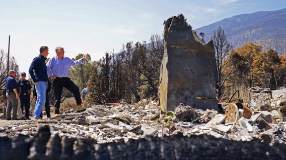 California Gov. Gavin Newsom, front left, and Nevada Gov. Steve Sisolak tour homes destroyed by wildfires near where the Tamarack Fire ignited earlier in July in Gardnerville, Nev., Wednesday, July 28, 2021. The governors of California and Nevada are calling for increased federal assistance as they tour an area blackened by one of several massive wildfires that have destroyed dozens of homes. Wednesday's tour of the Tamarack Fire along the state line comes as numerous wildfires char land and homes in a dozen states. 