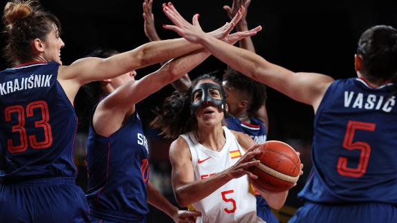 Spain's Cristina Ouviña, center, is defended by a group of Serbian players during a preliminary round basketball game on July 29.