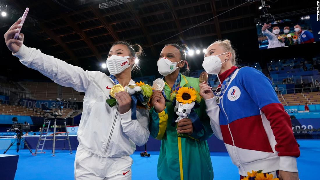 American gymnast Suni Lee takes a selfie with silver medalist Rebeca Andrade, center, and bronze medalist Angelina Melnikova after winning the individual all-around on July 29. Andrade is the first Brazilian to ever medal in women&#39;s gymnastics. Melnikova is Russian.
