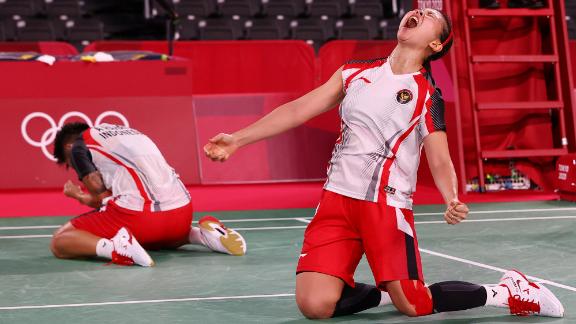 Indonesian badminton players Apriyani Rahayu and Greysia Polii react after winning their quarterfinal match on July 29.