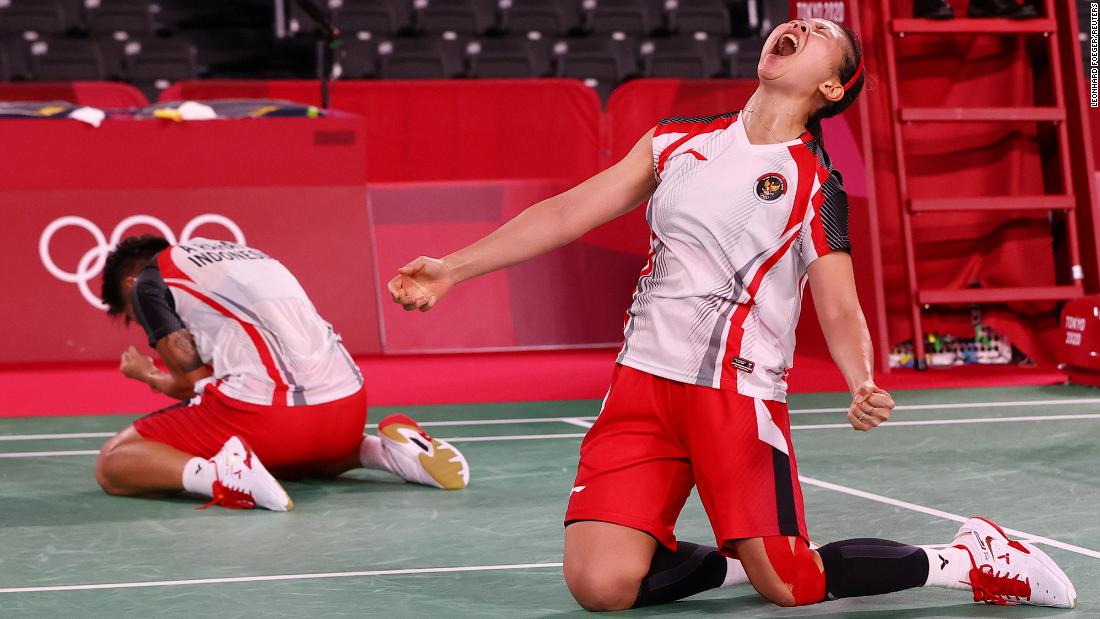 Indonesian badminton players Apriyani Rahayu and Greysia Polii react after winning their quarterfinal match on July 29.