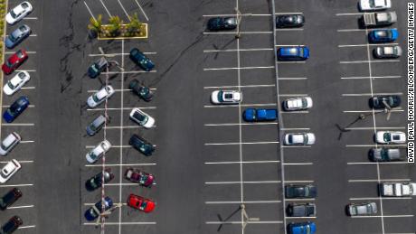 Vehicles in a nearly empty lot at a car dealership in California.