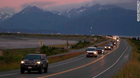 A line of cars evacuates the Homer Spit in Homer, Alaska, after a tsunami warning was issued following a magnitude 8.2 earthquake. The warning was later canceled.