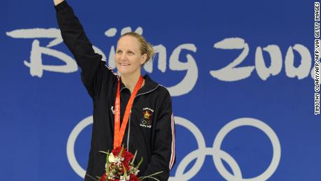 Gold medalist Zimbabwe&#39;s Kirsty Coventry stands on the podium for the women&#39;s 200m backstroke swimming final medal ceremony at the National Aquatics Center during the 2008 Beijing Olympic Games in Beijing on August 16, 2008.    Kirsty Coventry of Zimbabwe set a new world record in the women&#39;s 200 metres backstroke with a time of two minutes 05.24 seconds in the final at the Beijing Olympics. US swimmer Margaret Hoelzer placed second and Japanese swimmer Reiko Nakamura placed third.  AFP PHOTO / TIMOTHY CLARY (Photo credit should read TIMOTHY CLARY/AFP via Getty Images)
