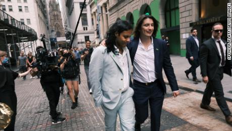 Baiju Bhatt (left) and Vlad Tenev, founders of the online brokerage Robinhood, walk along Wall Street after the company&#39;s initial public offering on July 29.