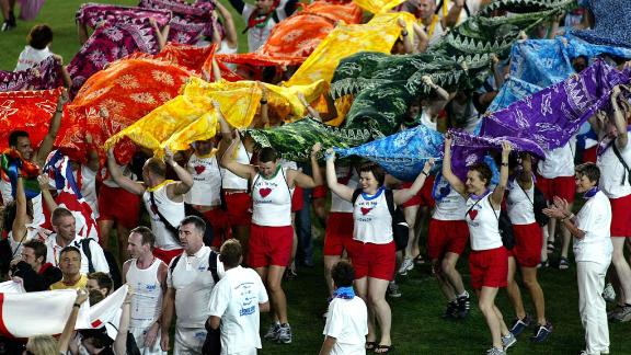 Participants from the United Kingdom team march onto the field during the opening ceremony of the 2002 Gay Games in Sydney, Australia.