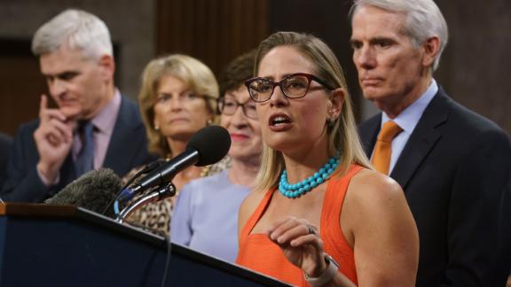 Sen. Kyrsten Sinema, D-Ariz., center, joined from left by, Sen. Bill Cassidy, R-La., Sen. Lisa Murkowski, R-Alaska, Sen. Susan Collins, R-Maine, and Sen. Rob Portman, R-Ohio, speak to reporters just after a vote to start work on a nearly $1 trillion bipartisan infrastructure package, at the Capitol in Washington, Wednesday, July 28, 2021. (AP Photo/J. Scott Applewhite)