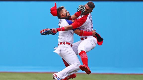 Dominican baseball players Gustavo Nunez, left, and Julio Rodriguez collide as Rodriguez catches a ball during their 1-0 win over Mexico on July 30.