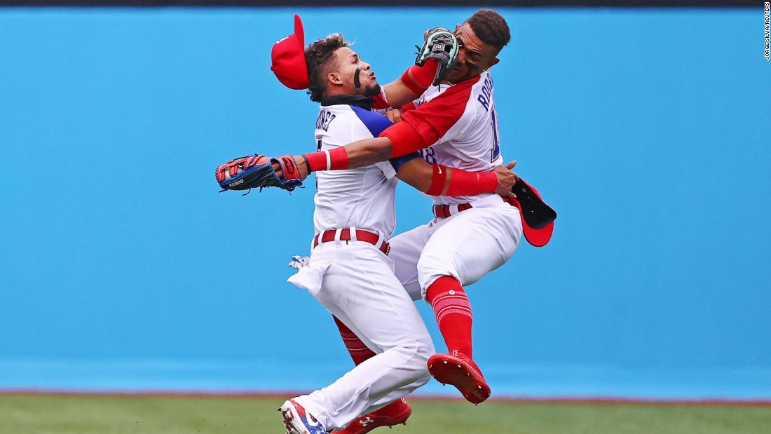 Dominican baseball players Gustavo Nunez, left, and Julio Rodriguez collide as Rodriguez catches a ball during their 1-0 win over Mexico on July 30.