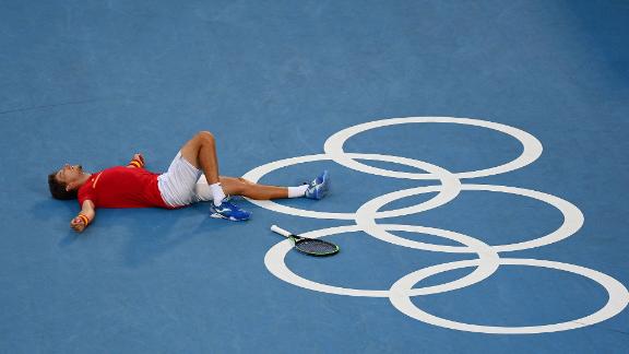 Spanish tennis player Pablo Carreño Busta celebrates after he defeated Serbia's Novak Djokovic to win bronze on July 31.
