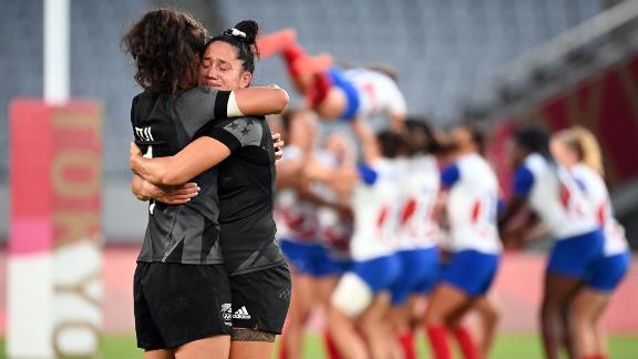 Members of New Zealand's rugby team hug after defeating France <a href=