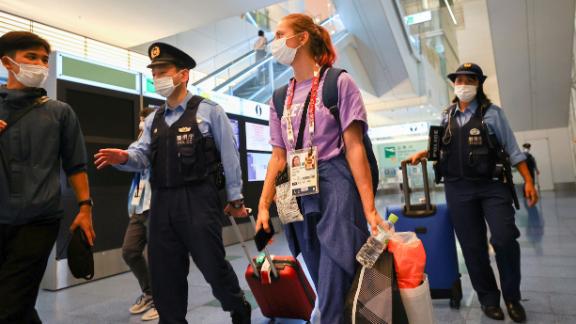 Belarusian athlete Kristina Timanovskaya is escorted by police officers at Haneda international airport in Tokyo, Japan August 1.