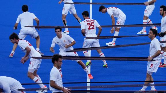 Field hockey players from Spain warm up before their match against Belgium on August 1.
