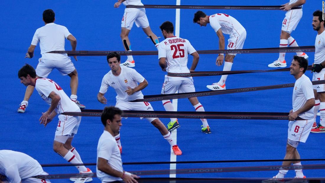 Field hockey players from Spain warm up before their match against Belgium on August 1.