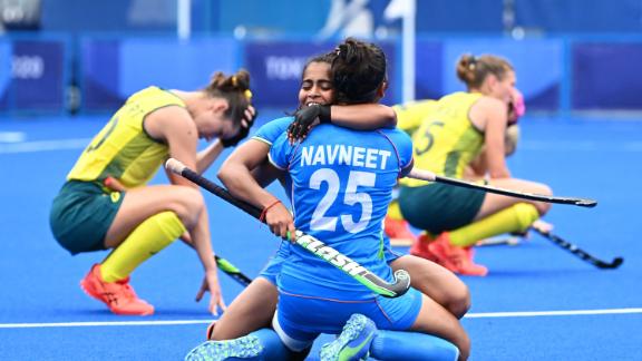 India's Neha Goyal embraces Navneet Kaur after a 1-0 win over Australia in a field hockey quarterfinal on August 2.